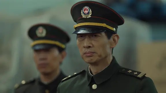 两名穿制服戴大檐帽的男子站在室外