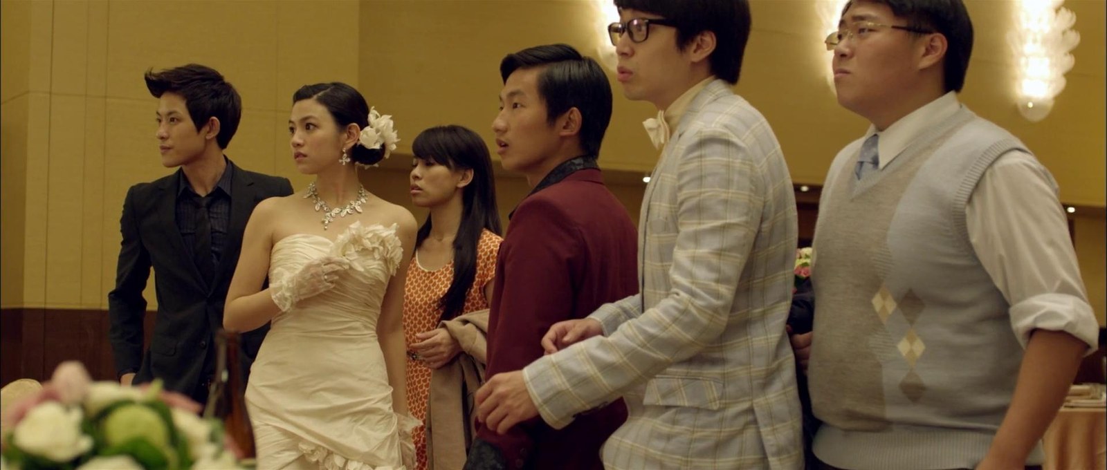穿婚纱的女子与数名男子站在婚宴厅里