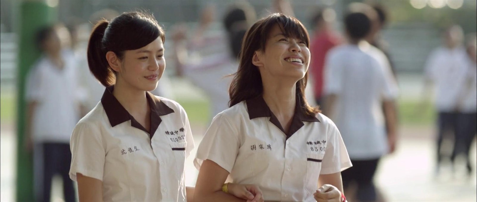 两名穿校服的女生并肩走过校园